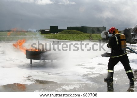 Firefighter putting out a fire (drill)