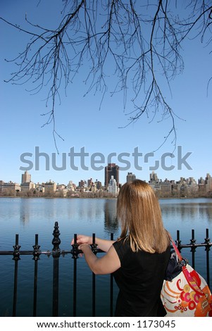 Girlfriend of mine looking at the buildings across the water reservoir in Central Park, New York