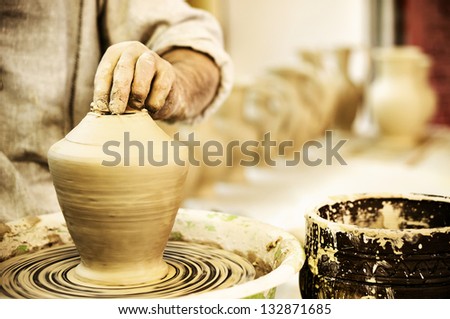 Potter works. Crockery creation process in pottery on potters\' wheel. Video footage also available.