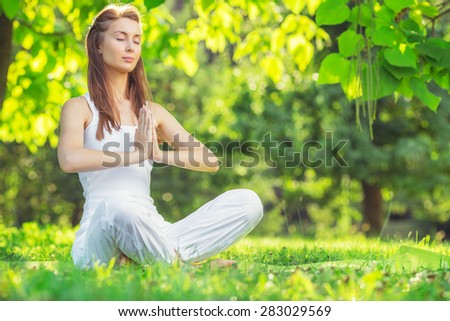 Yoga outdoors. Young woman making namaste symbol. Concept of healthy lifestyle and relaxation.