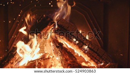 Fireplace burning. Warm cozy burning fire in a brick fireplace close up. Cozy background