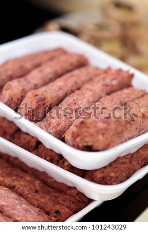 Closeup of a meat rolls (sausages)  and mushrooms ready for grill