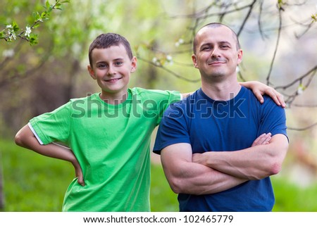Happy father and son outdoor in the garden