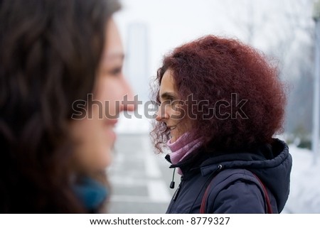 Concept of misunderstanding with two women talking in the wrong direction