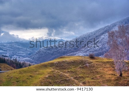High dynamic range landscape with mountains in a cloudy day