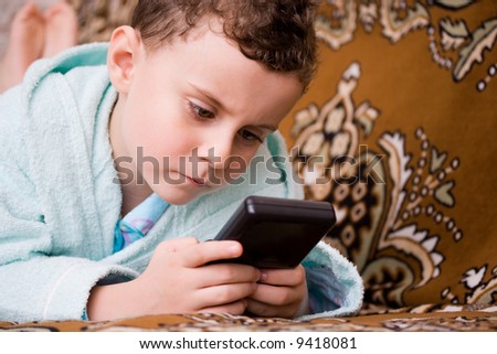 Beautiful boy playing at an electronic game