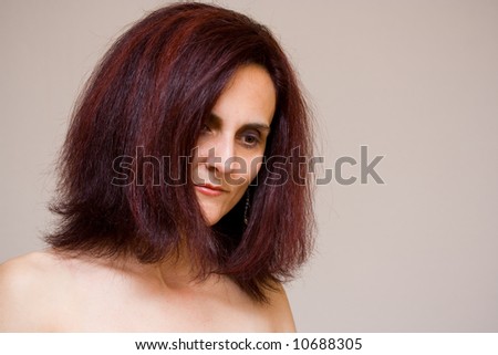 Portrait of a beautiful redhead woman smiling, indoor scene