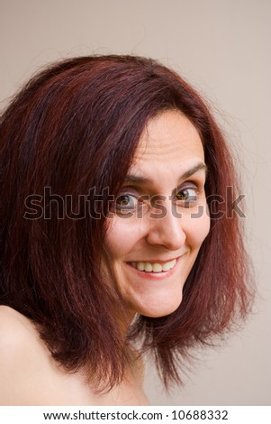 Portrait of a beautiful redhead woman smiling, indoor scene