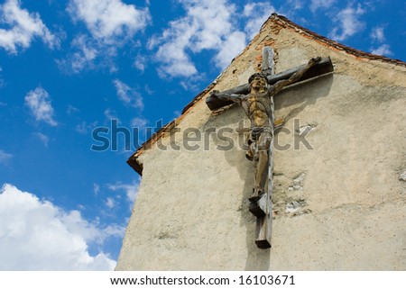 Big wooden cross with sculpted Christ on a building from a castle in Romania