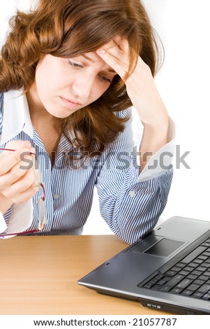 Pensive businesswoman sitting in front of a laptop, concentrating to find an idea