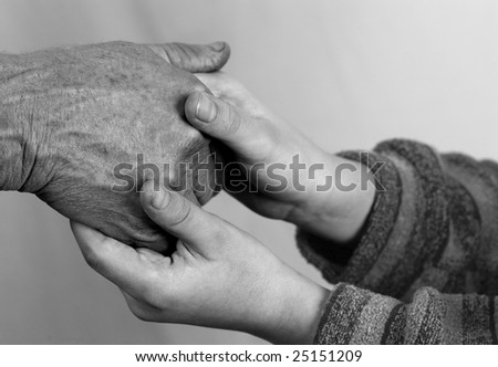 Old woman hands and child hands together
