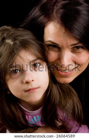 Mother and daughter playing together, isolated on black