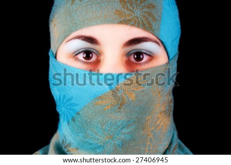 Muslim young woman with blue veil isolated on black
