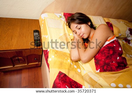 Beautiful young lady sleeping on her bed