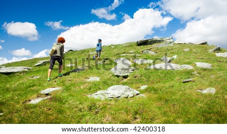 Mother and son hiking in a mountain landscape