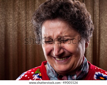 Close up portrait of an old woman having a good laugh