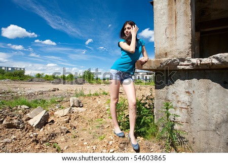 Portrait of a beautiful young woman in an industrial background