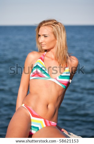 Portrait of a beautiful young blond lady at the sea