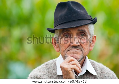 Portrait of a wrinkled and expressive old farmer outdoor
