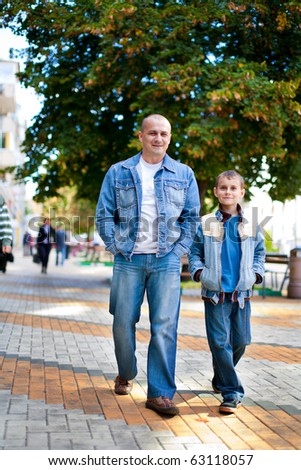 Father and son taking a walk outdoor in a park