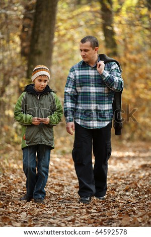stock photo : Father and son talking a walk outdoor in a forest, in an
