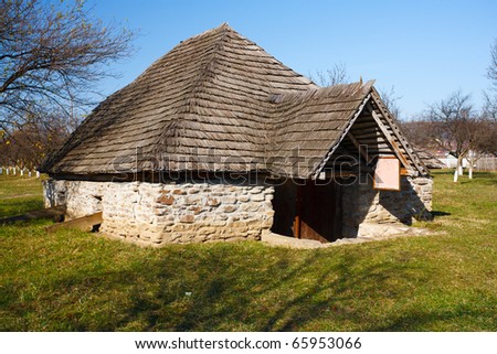 Old traditional Romanian barn or shack under blue sky - this is part of a series of images with countryside buildings in Romania