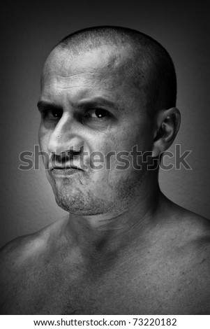 Monochrome toned closeup portrait of a tough man with intense look