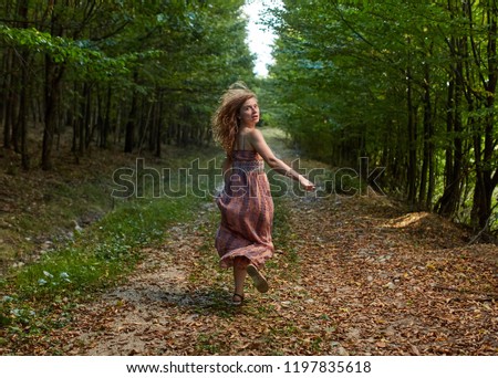 Scared woman running through the forest