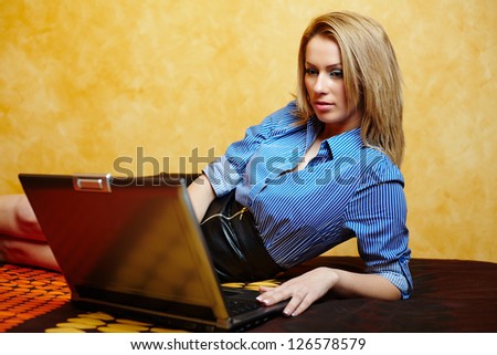 Young attractive businesswoman using her laptop in bed, after work hours