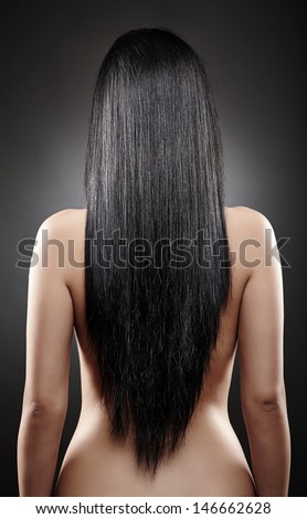 Closeup of the back of a young caucasian woman with beautiful black hair