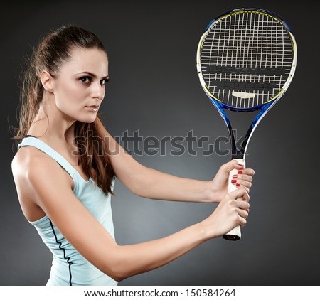 Studio shot of a young woman executing a backhand volley