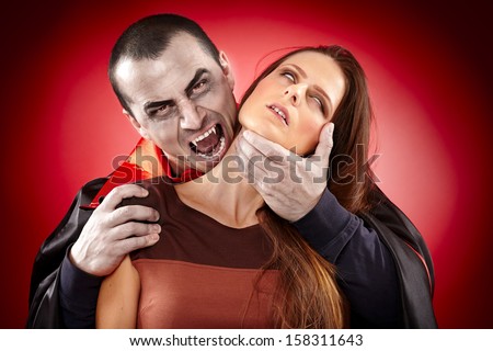 Vampire preparing to bite a beautiful woman\'s neck