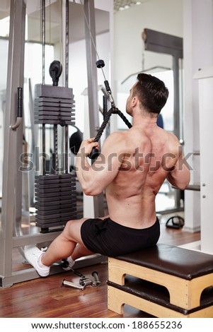 Man lifting weights at the cable machine in a gym