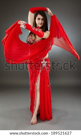 Beautiful ethnic bellydancer performing oriental dance in traditional costume