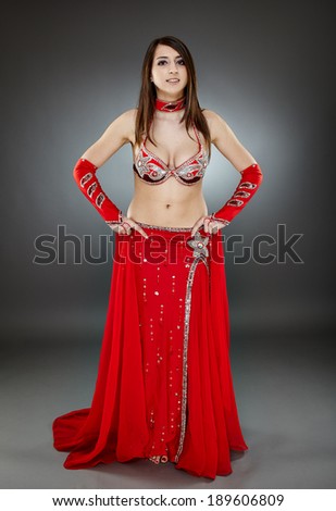 Beautiful ethnic bellydancer performing oriental dance in traditional costume