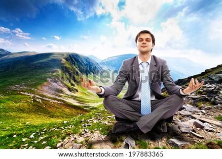 Young businessman relaxing in the mountains, away from the city life and business meetings