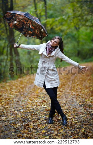Young caucasian woman taking a walk in the forest, autumnal portrait