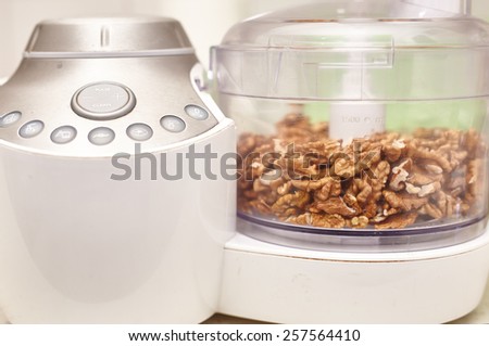 Kernel walnuts in a food processor ready to be crushed for prepare dessert