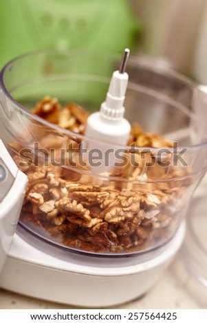 Kernel walnuts in a food processor ready to be crushed for prepare dessert