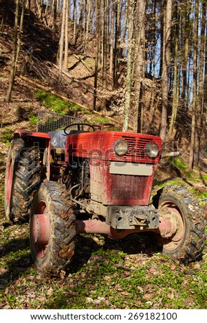 Logging tractor with an anchor winch in the forest