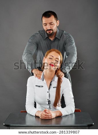 Lady boss getting a massage from her handsome employee