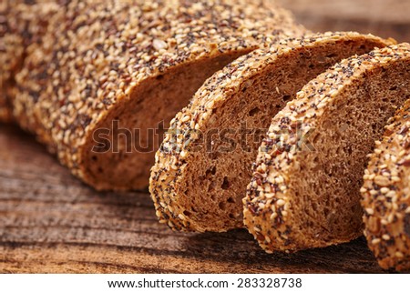 Closeup of rye bread with seeds on a wooden board