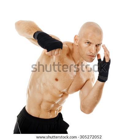 Muscular kickbox or muay thai fighter punching, isolated on white background