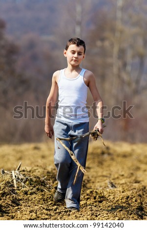 http://image.shutterstock.com/display_pic_with_logo/113008/99142040/stock-photo-kid-walking-on-plowed-soil-holding-a-corn-stalk-99142040.jpg