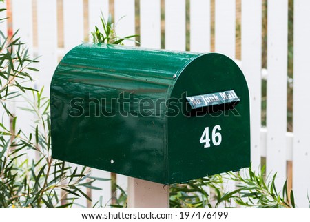 Green mail box with the number 42 on it.