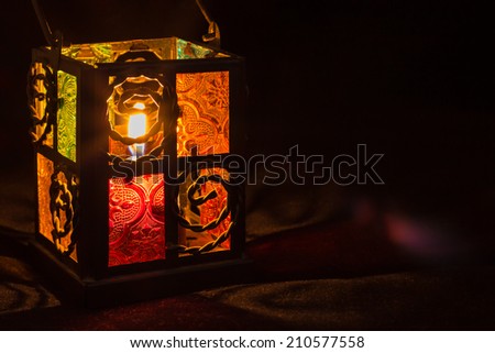 Candle lantern box with small glass windows.