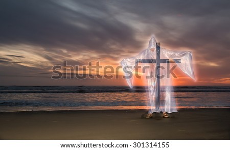 Transparent image of Jesus Christ with a cross on a beach at sunset.