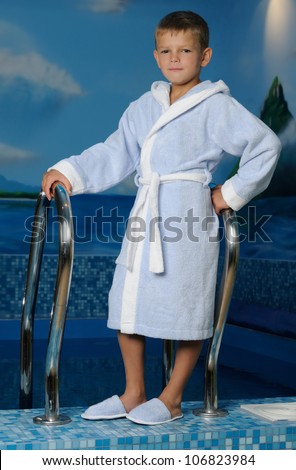 Happy little boy by pool
