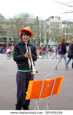 AMSTERDAM - APRIL 30:  Dutch annual national holiday, in the streets of the city, with unidentified boy on April 30, 2013 in Amsterdam, The Netherlands