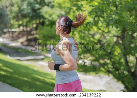 young fit jogger running on park pathway. Running and jogging exercising concept.